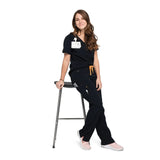 Leaning full body picture of the the Bodie scrub pants in black.