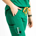 Close up pocket picture of the the Bodie scrub pants in hunter green.