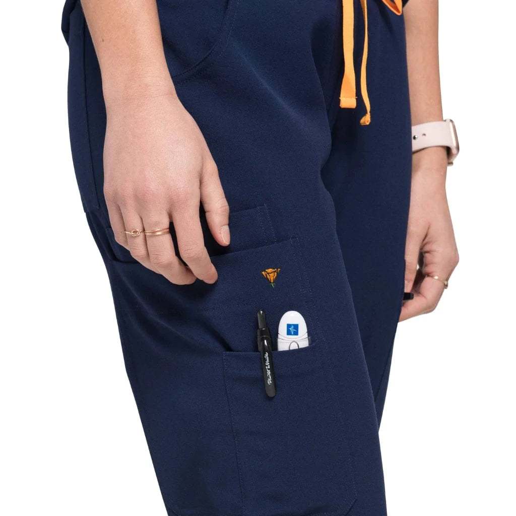 Close up pocket picture of the the Bodie scrub pants in navy blue.