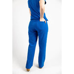 Backside close up body picture of the the Bodie scrub pants in royal blue.