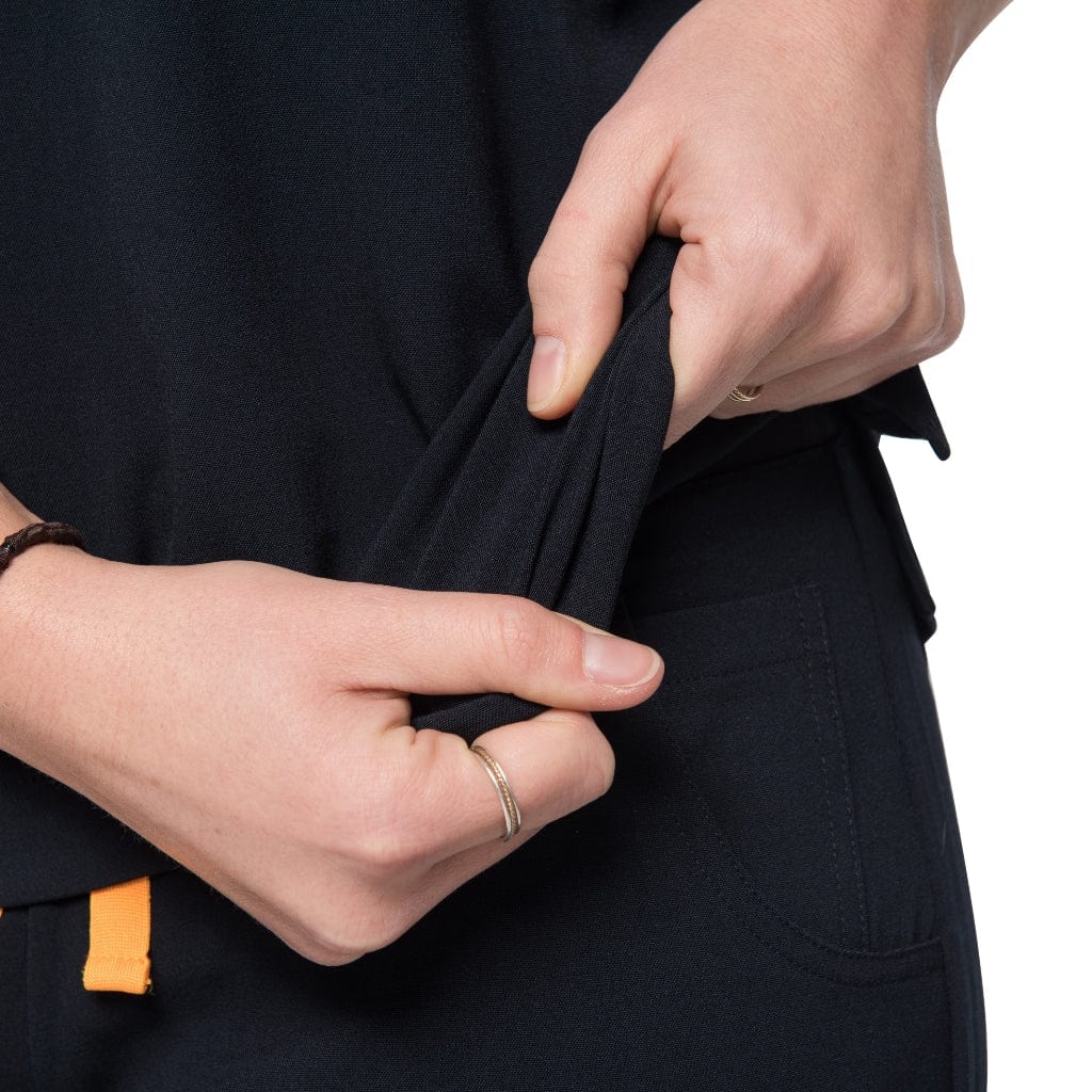 Fabric stretch detail picture of the the Caswell scrub top in black.