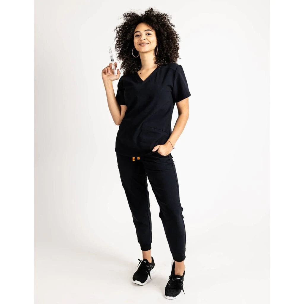 Full body picture of the the Caswell scrub top in black.