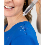 Water repellant detail picture of the the Caswell scrub top in royal blue.