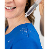 Water repellant detail picture of the the Caswell scrub top in royal blue.