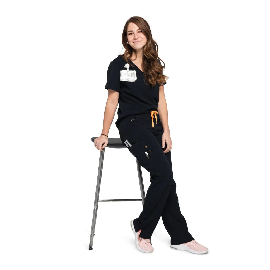 Full body picture of the wilder one-pocket scrub top in black