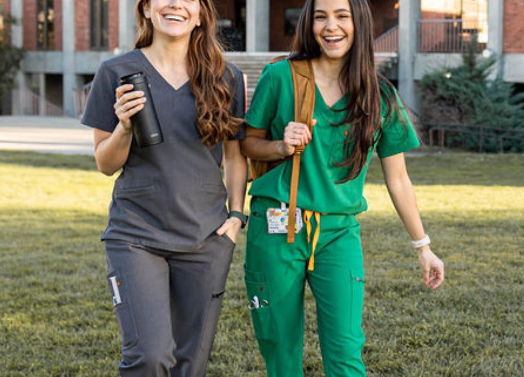 Photo of charcoal and hunter green scrubs outside hospital.