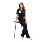 Leaning full body picture of the the Bodie scrub pants in black.