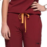 Close up front picture of the the Bodie scrub pants in burgundy.