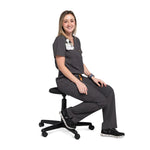 Seated front full body picture of the the Bodie scrub pants in charcoal gray.