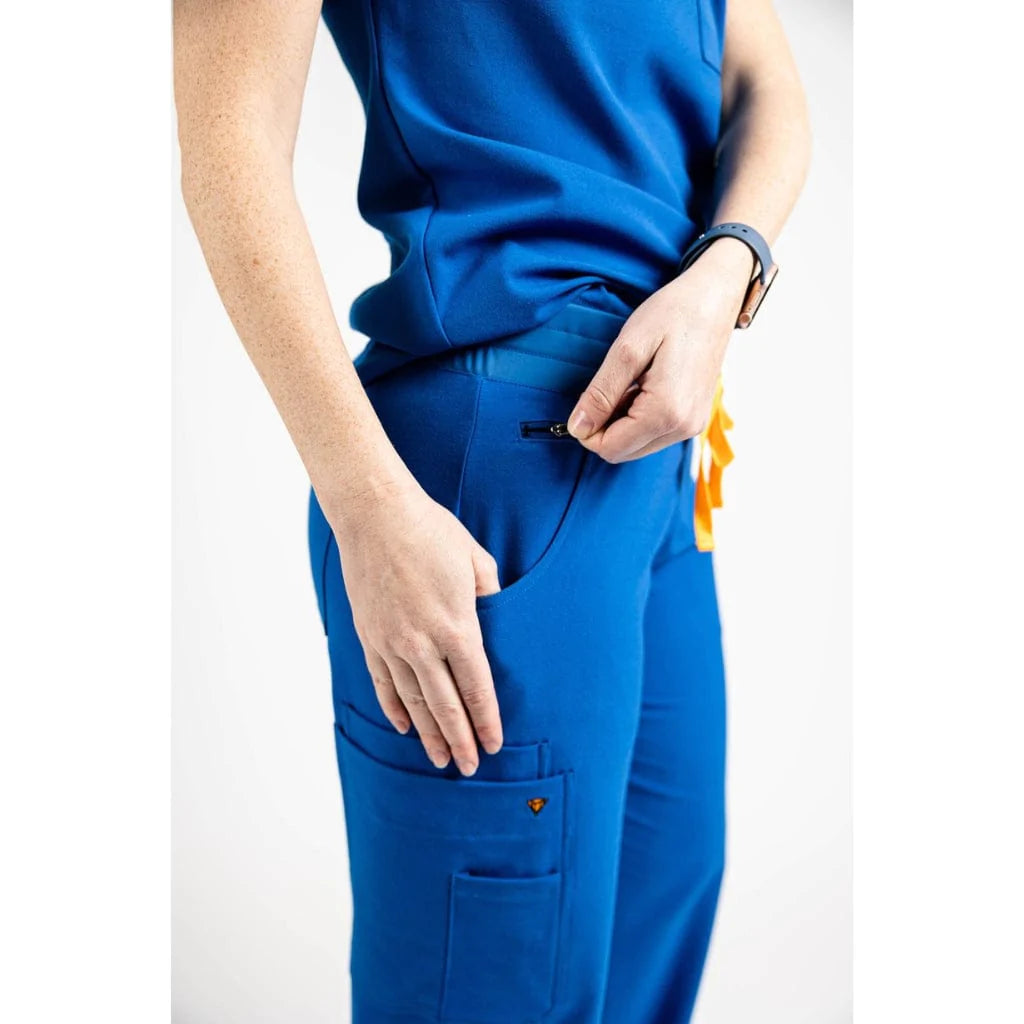 Close up pocket picture of the the Bodie scrub pants in royal blue.