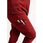 Pocket detail picture of the the Hatton jogger scrub pants in burgundy.