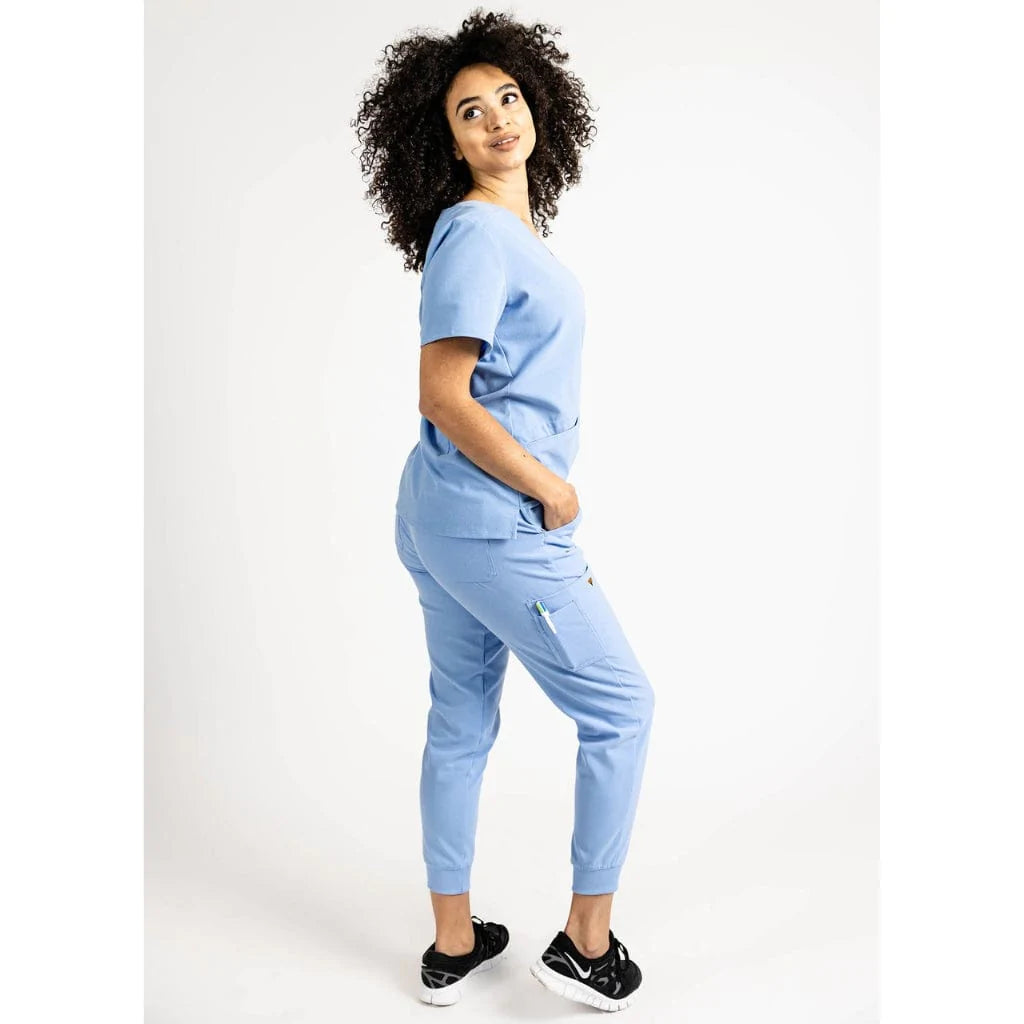 Side full body picture of the the Hatton jogger scrub pants in ceil blue.