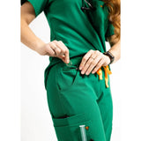Lower front pocket detail picture of the the Pfeiffer scrub pants in hunter green.