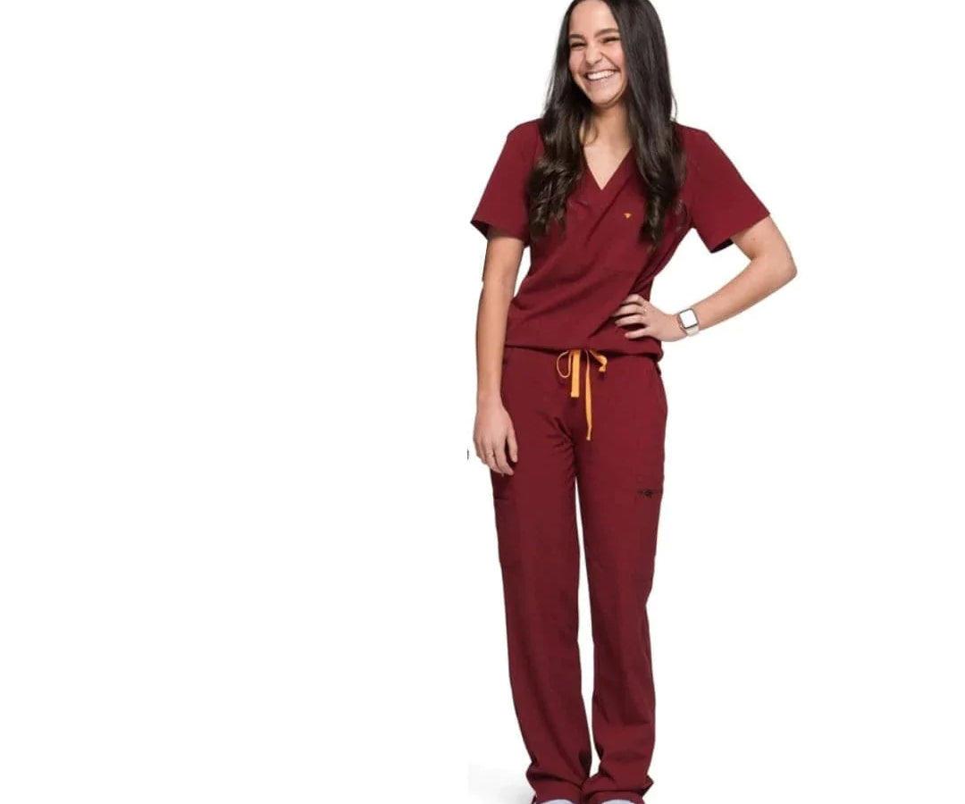 Full body picture of the the Bodie scrub pants in burgundy.