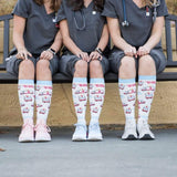 Seated on bench detail photo of Wee Woo compression socks.