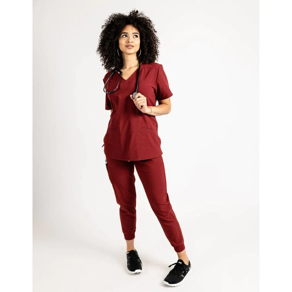 Full body picture of the the Caswell scrub top in burgundy.