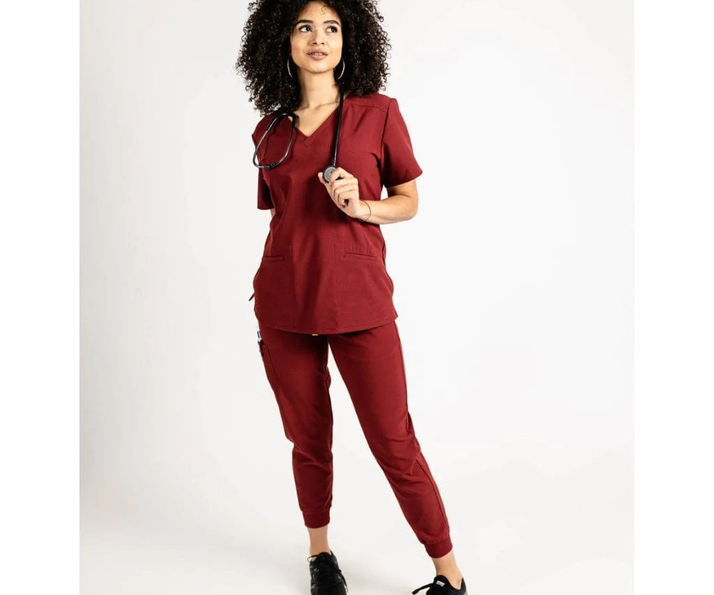 Full body picture of the the Caswell scrub top in burgundy.