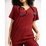 Stretch detail picture of the the Caswell scrub top in burgundy