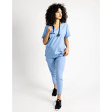 Full body picture of the the Caswell scrub top in ceil blue.