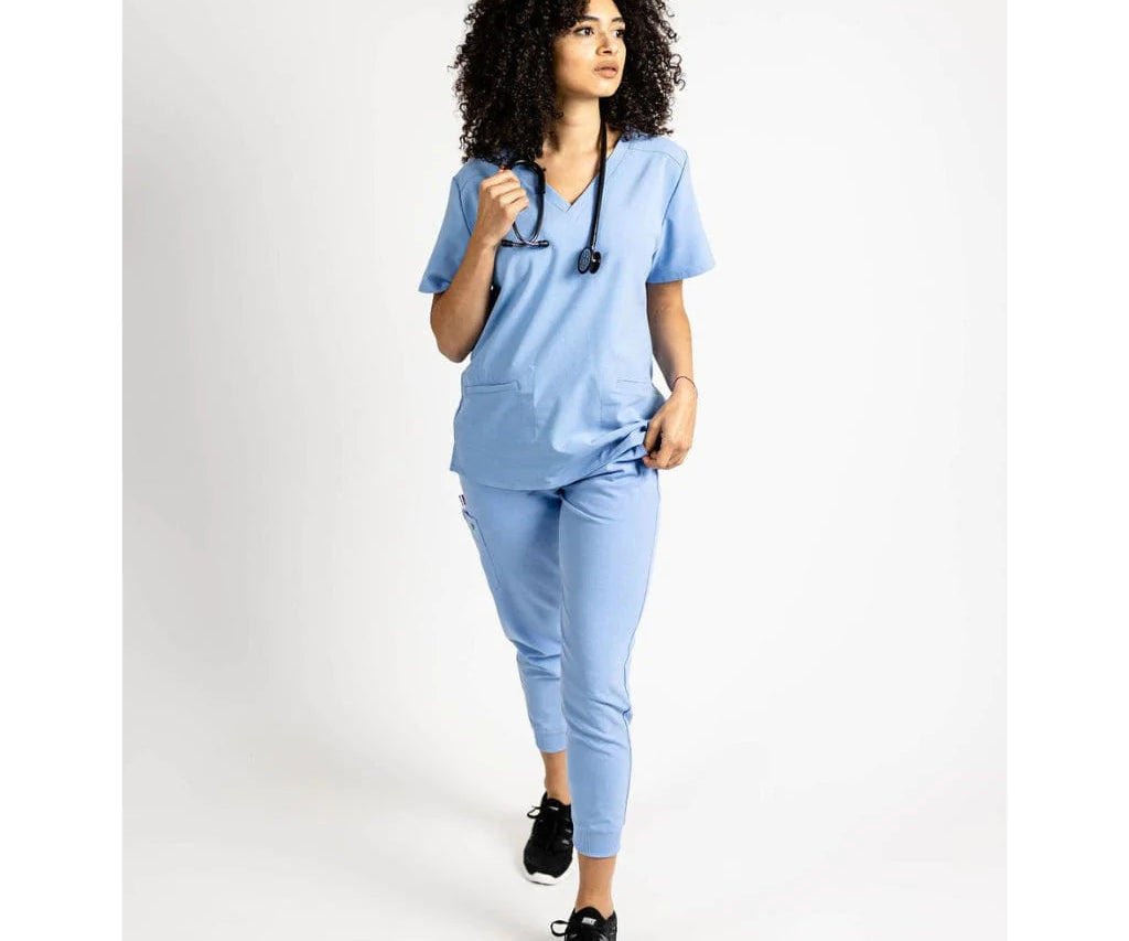 Full body picture of the the Caswell scrub top in ceil blue.