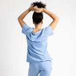 Back side picture of the the Caswell scrub top in ceil blue.