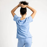 Back side picture of the the Caswell scrub top in ceil blue.