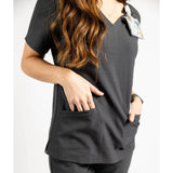 Upper front pocket detail picture of the the Caswell scrub top in charcoal gray.