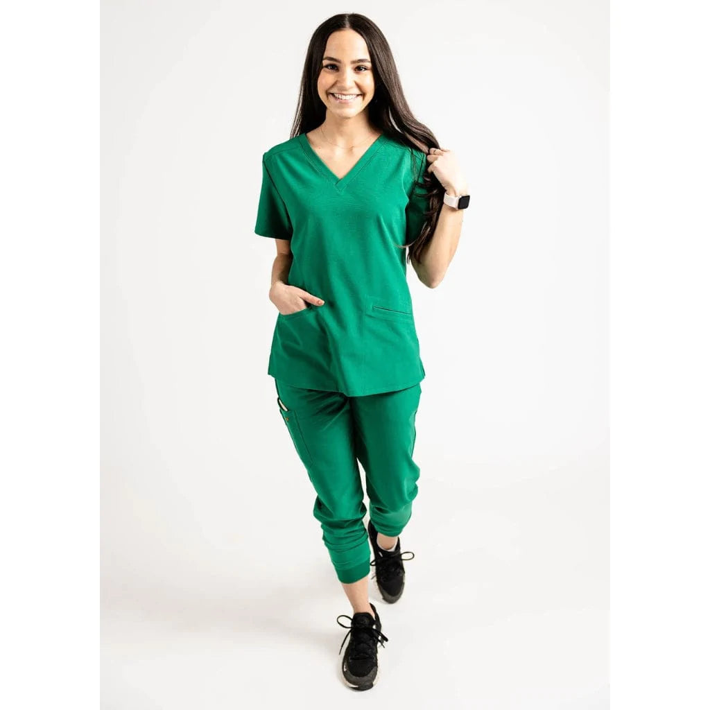 Full body picture of the the Caswell scrub top in hunter green.