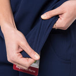 Fabric stretch detail picture of the the Caswell scrub top in navy blue.