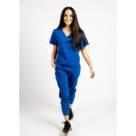 Full body picture of the the Caswell scrub top in royal blue.