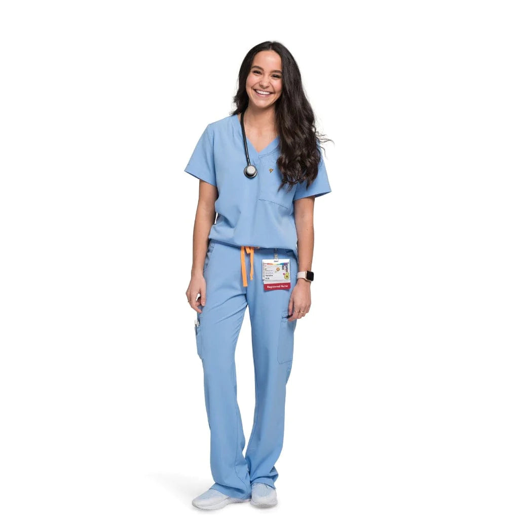 Full body picture of the wilder one-pocket scrub top in ceil blue.