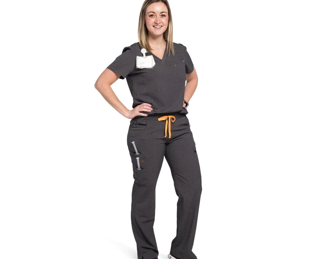Full body picture of the wilder one-pocket scrub top in charcoal gray.