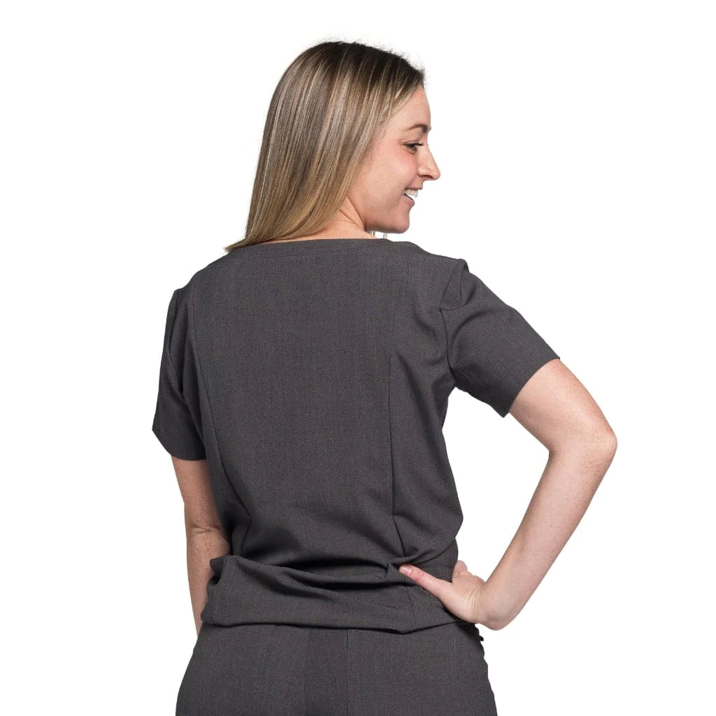 Back picture of the wilder one-pocket scrub top in charcoal gray.