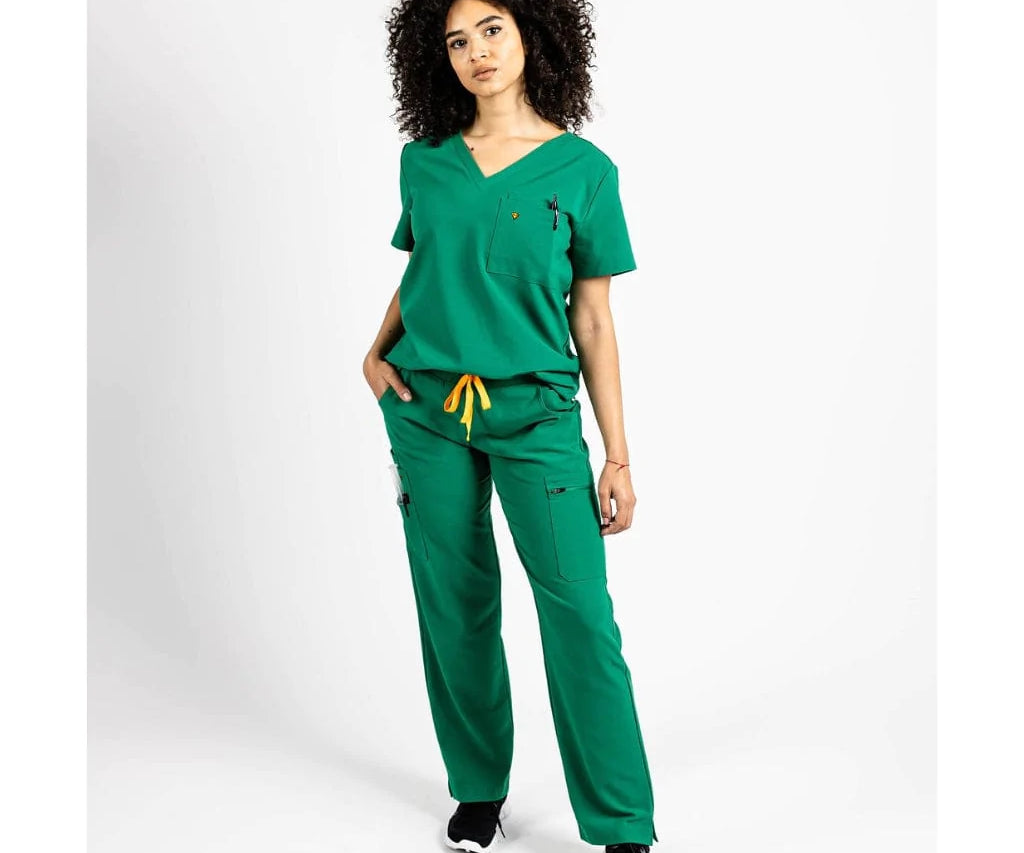 Full body picture of the wilder one-pocket scrub top in hunter green.