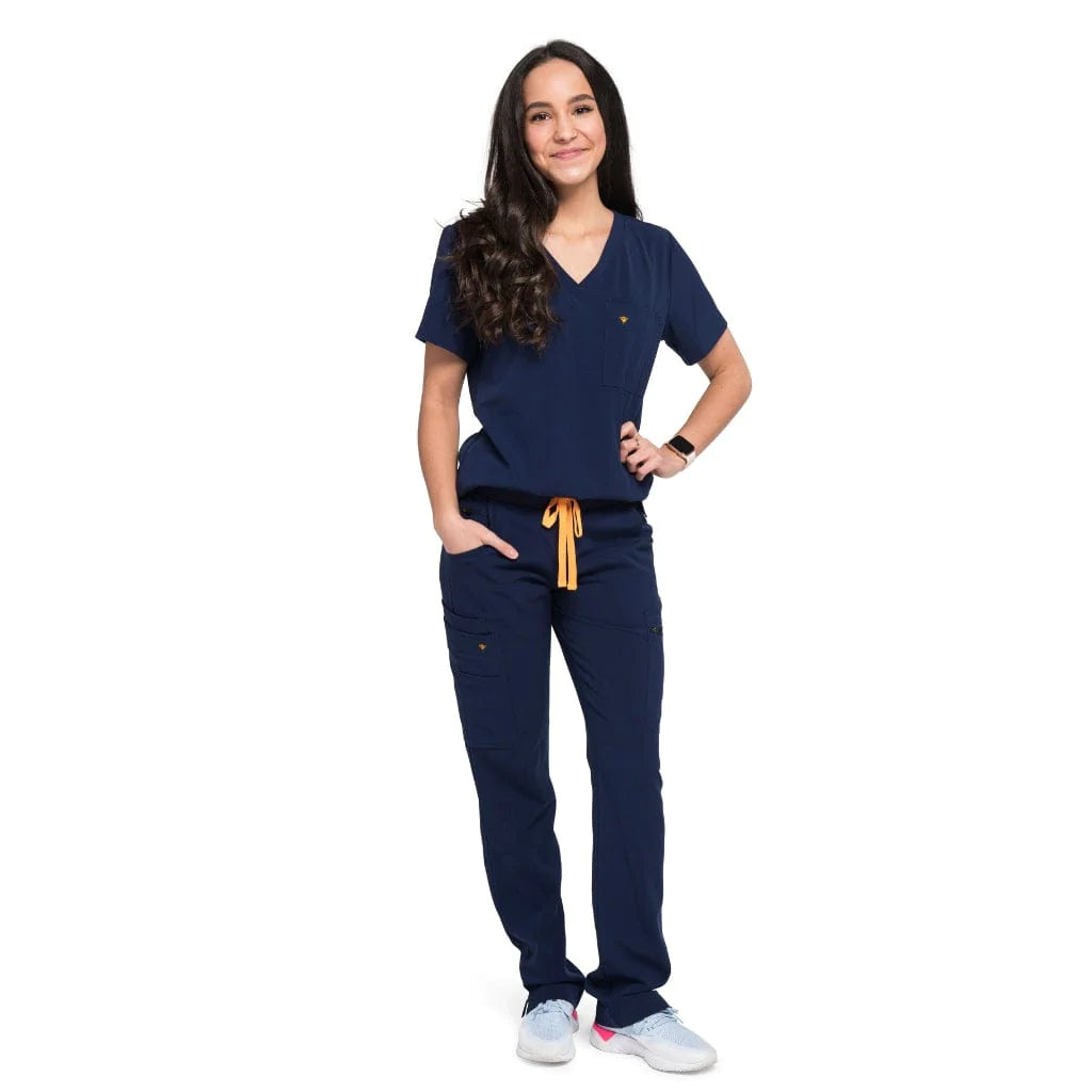 Full body picture of the wilder one-pocket scrub top in navy blue.