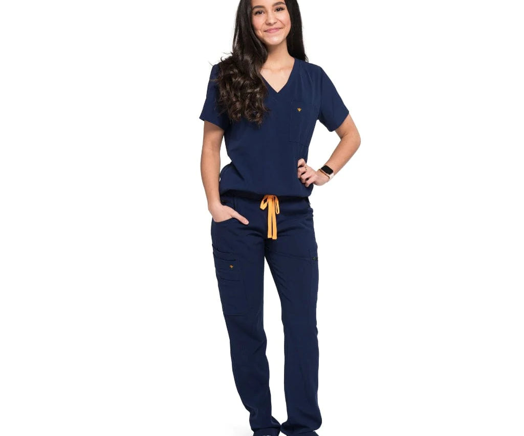 Full body picture of the wilder one-pocket scrub top in navy blue.