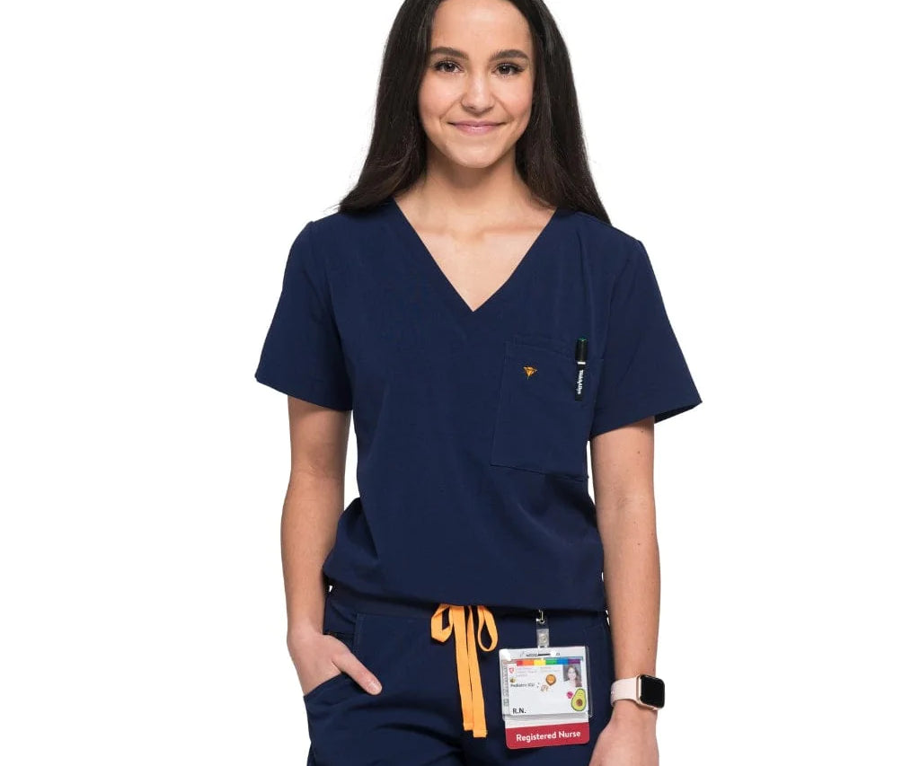 Front shot of the wilder one-pocket scrub top in navy blue.