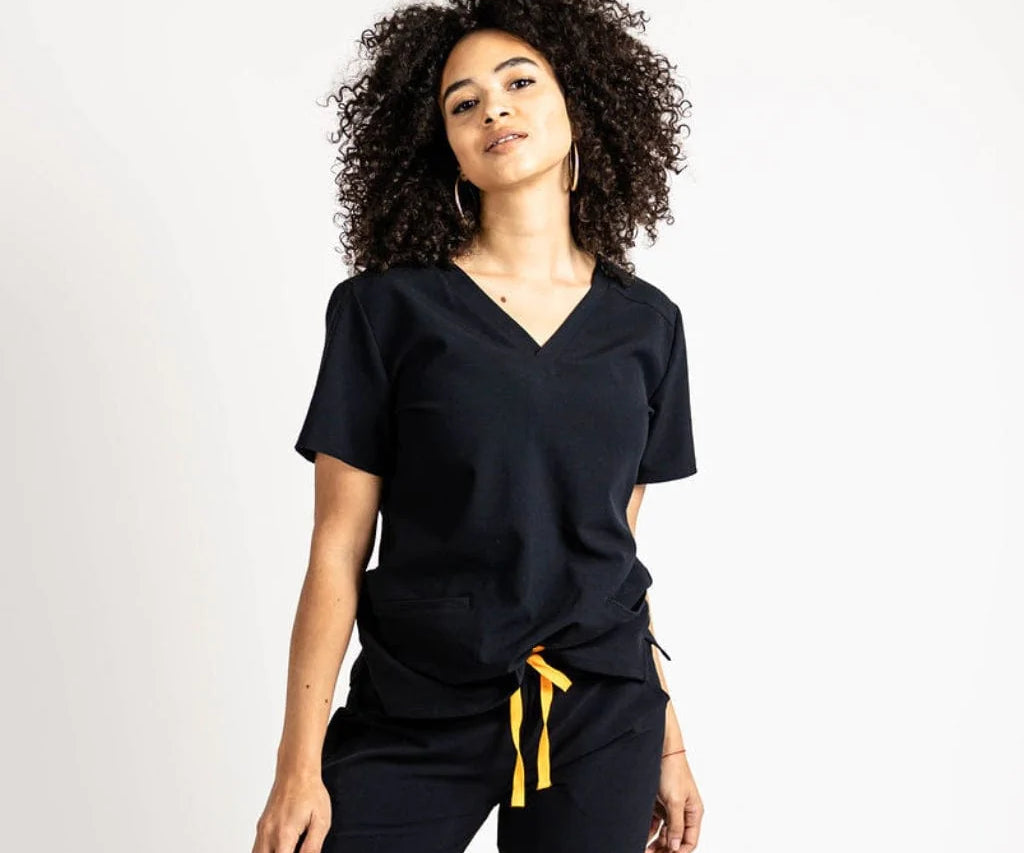 Upper front picture of the the Caswell scrub top in black.