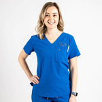 Front shot of the wilder one-pocket scrub top in royal blue.
